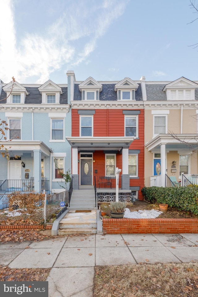 multi unit property with covered porch and mansard roof