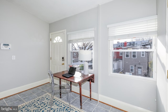 office area with baseboards and tile patterned floors