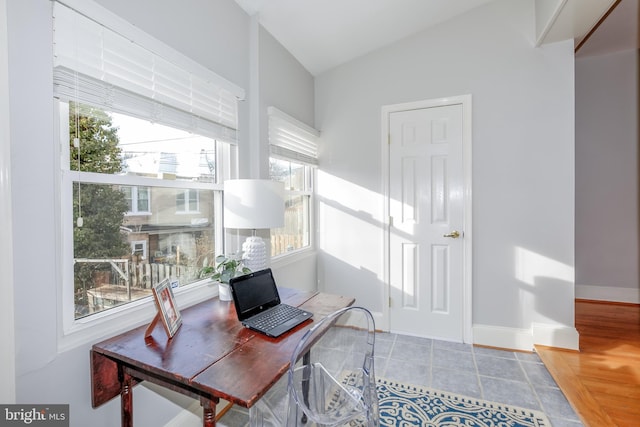 office area with vaulted ceiling and baseboards