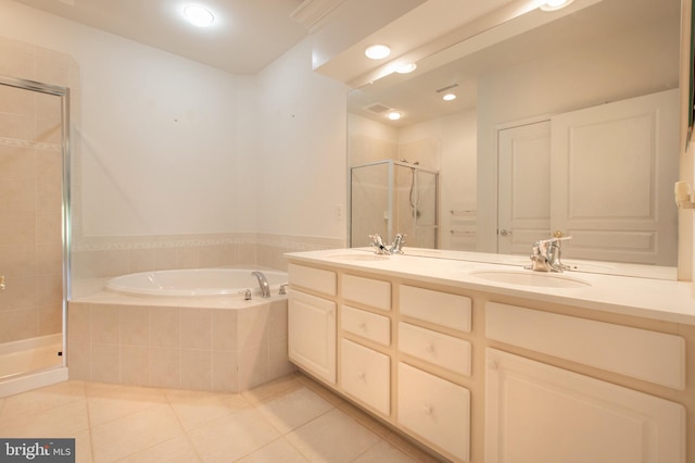 bathroom with a garden tub, a stall shower, tile patterned flooring, and a sink