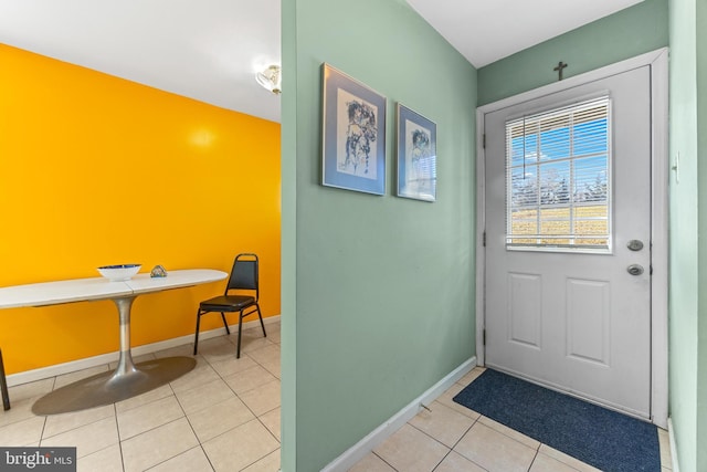 entryway with light tile patterned floors and baseboards