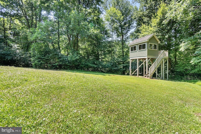 view of yard with a deck and stairway