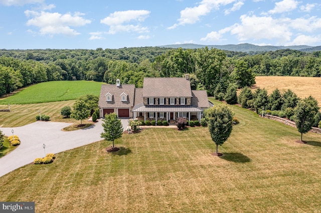 drone / aerial view featuring a mountain view and a wooded view