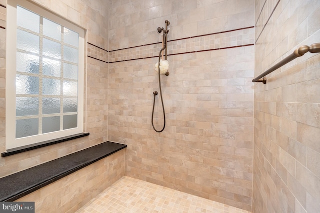 bathroom with a tile shower