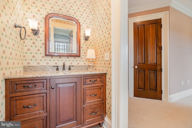 bathroom featuring ornamental molding, vanity, baseboards, and wallpapered walls