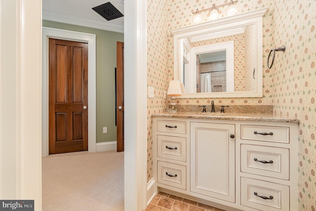 full bath featuring crown molding, vanity, baseboards, and wallpapered walls