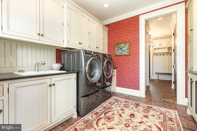 laundry area featuring brick floor, independent washer and dryer, cabinet space, and wallpapered walls