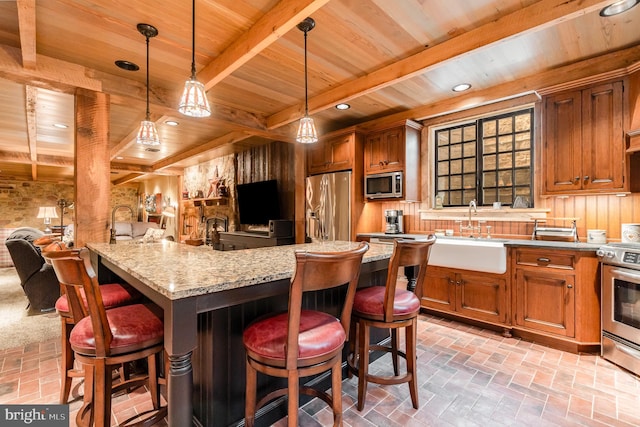 kitchen featuring wood ceiling, a kitchen bar, stainless steel appliances, and decorative light fixtures