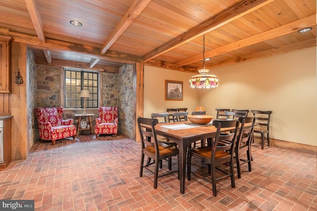 dining space with beam ceiling, brick floor, wood ceiling, and recessed lighting