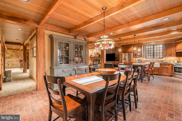 dining room featuring brick floor, beamed ceiling, and wooden ceiling