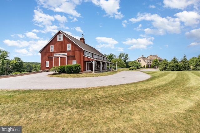 exterior space featuring a garage, a lawn, and driveway