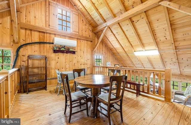 dining space featuring beam ceiling, light wood-style flooring, wood ceiling, wood walls, and a wall mounted air conditioner