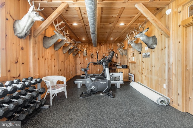 workout room featuring wood walls