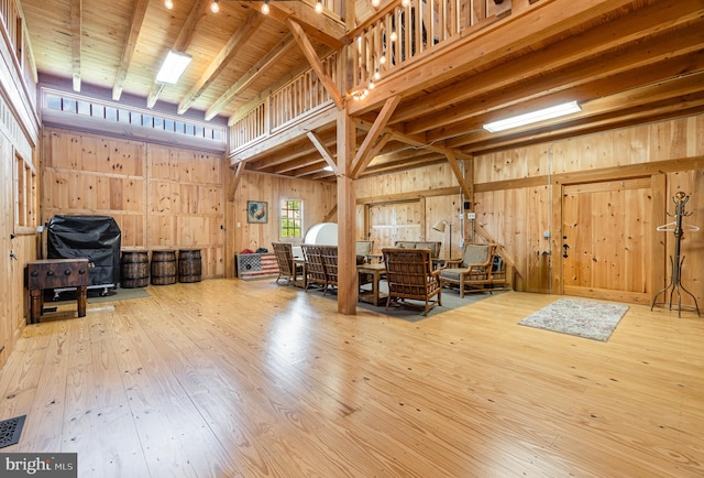 misc room featuring wooden walls and hardwood / wood-style floors