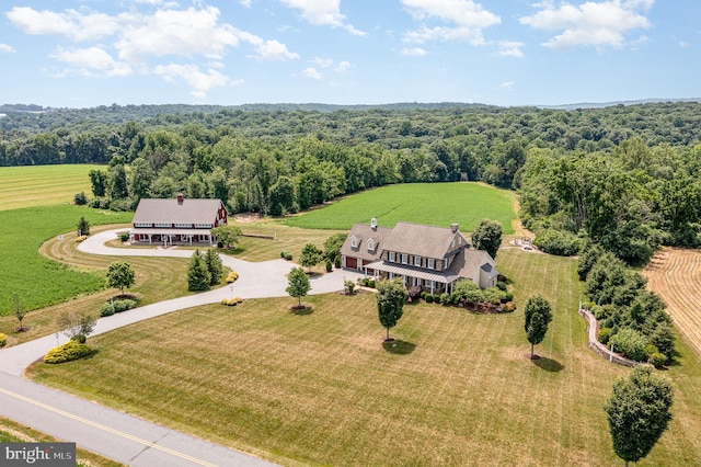 birds eye view of property with a wooded view and a rural view