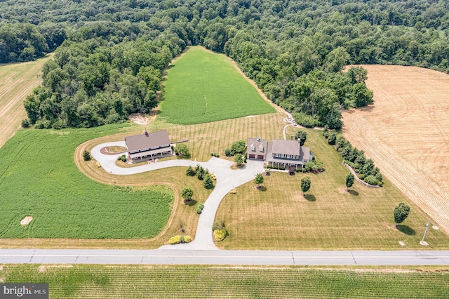 bird's eye view featuring a wooded view and a rural view