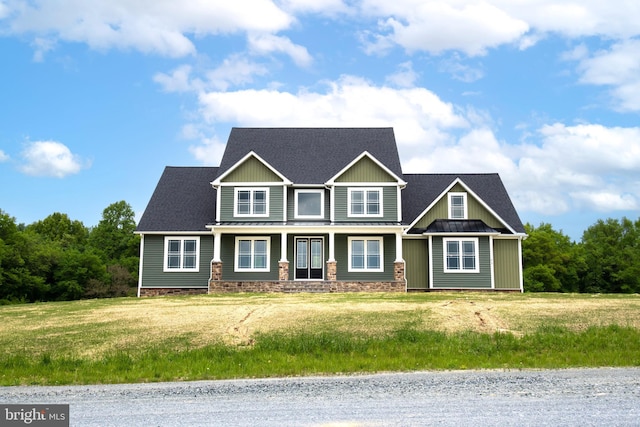 craftsman house featuring metal roof, a standing seam roof, and a front yard