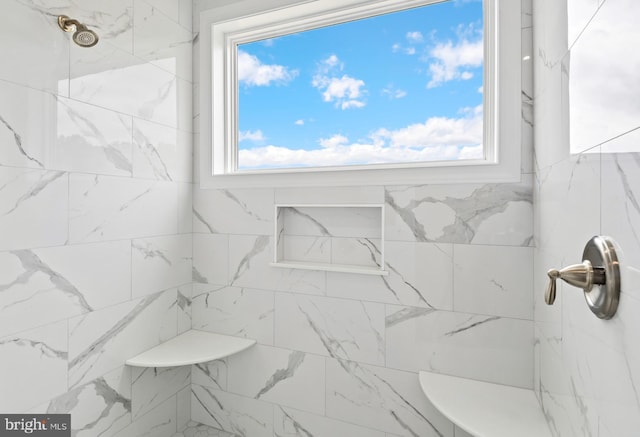 bathroom with a tile shower