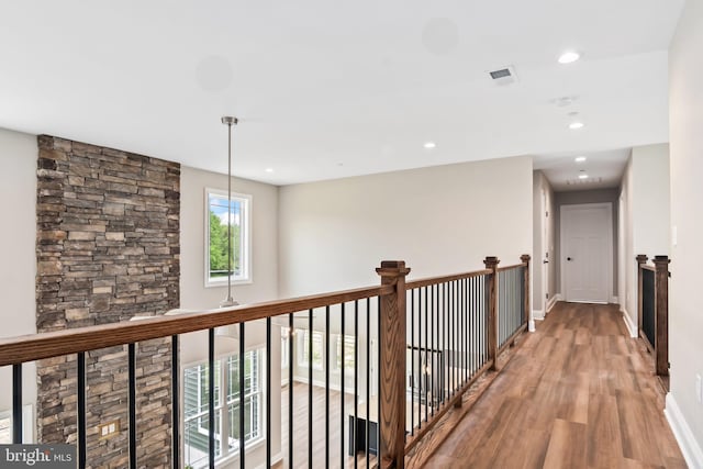 corridor with recessed lighting, wood finished floors, visible vents, and baseboards