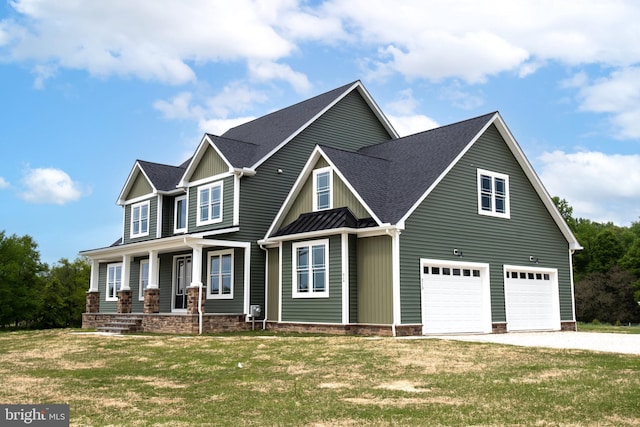 craftsman inspired home featuring covered porch, concrete driveway, a front lawn, and a garage