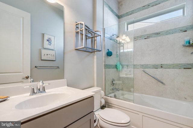 full bathroom featuring enclosed tub / shower combo, vanity, and toilet