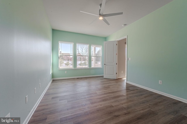 unfurnished bedroom with ceiling fan, baseboards, and wood finished floors