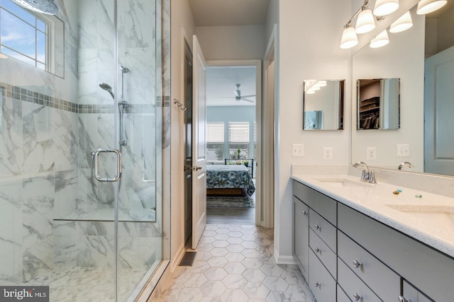 ensuite bathroom with a sink, connected bathroom, a marble finish shower, and double vanity