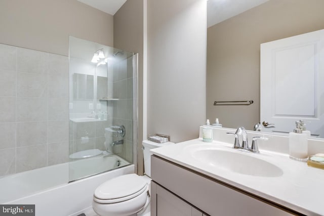 bathroom featuring combined bath / shower with glass door, vanity, and toilet