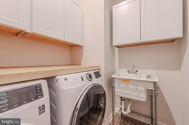 laundry room with cabinet space and washer and clothes dryer