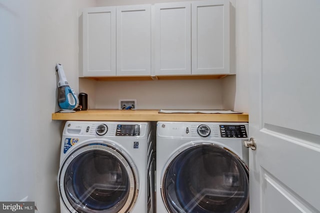 laundry area with cabinet space and separate washer and dryer