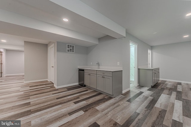 bar with dishwasher, recessed lighting, light wood-type flooring, and baseboards