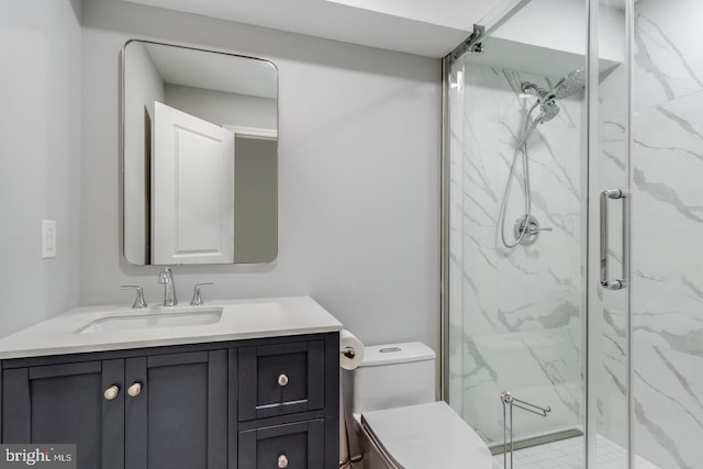 full bath featuring toilet, a marble finish shower, and vanity