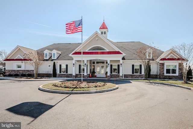 view of building exterior with curved driveway