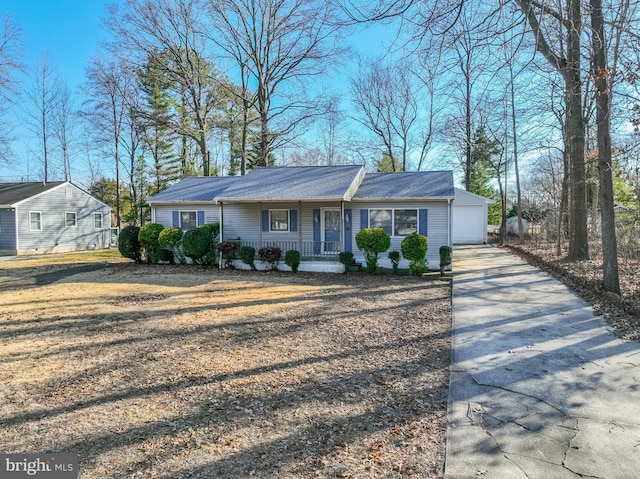 single story home featuring a porch and a garage