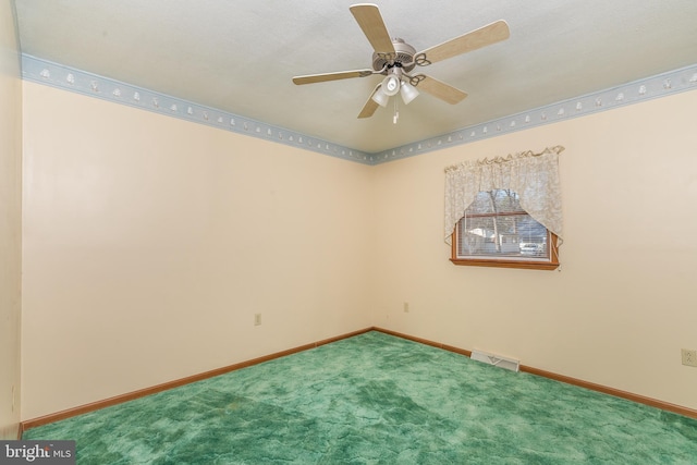 spare room with a ceiling fan, carpet, visible vents, and baseboards