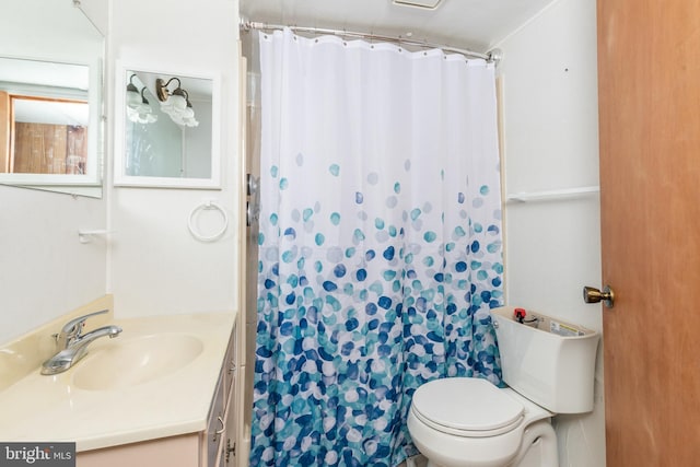 bathroom featuring toilet, curtained shower, and vanity