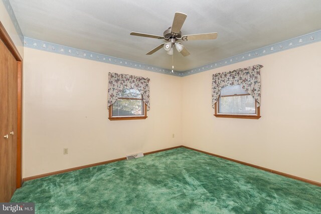 interior space with carpet, visible vents, baseboards, and a closet