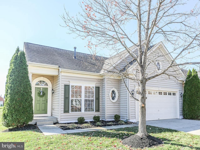 view of front of property with an attached garage, a front lawn, concrete driveway, and roof with shingles