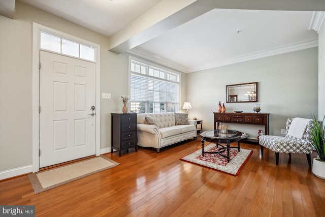 entryway with crown molding, baseboards, and hardwood / wood-style floors