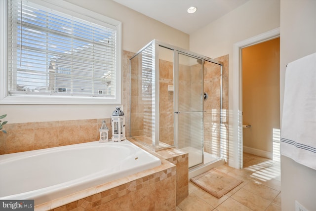 full bathroom featuring a stall shower, a garden tub, and tile patterned floors