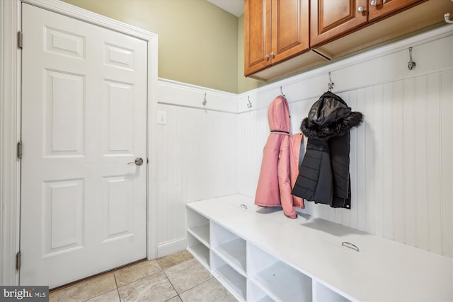 mudroom with wainscoting and light tile patterned flooring