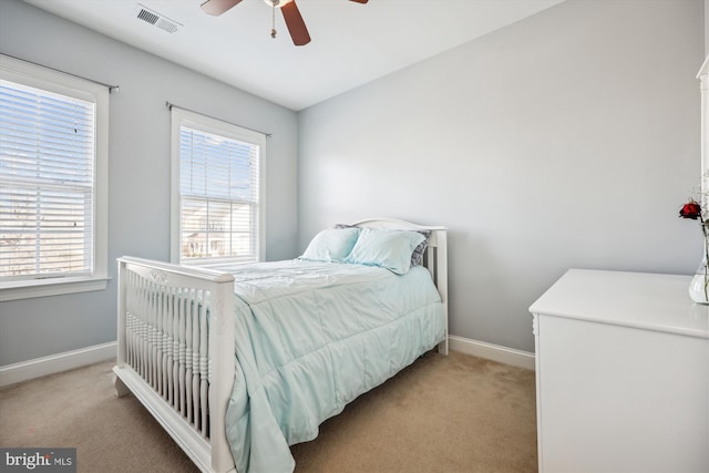 bedroom with light carpet, baseboards, multiple windows, and visible vents