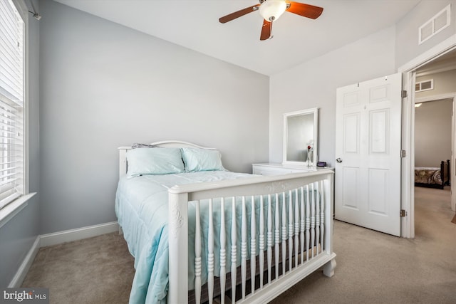 bedroom with light carpet, multiple windows, and visible vents