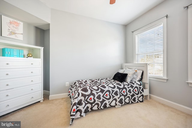 carpeted bedroom featuring a ceiling fan and baseboards