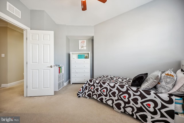 carpeted bedroom with baseboards, visible vents, and a ceiling fan