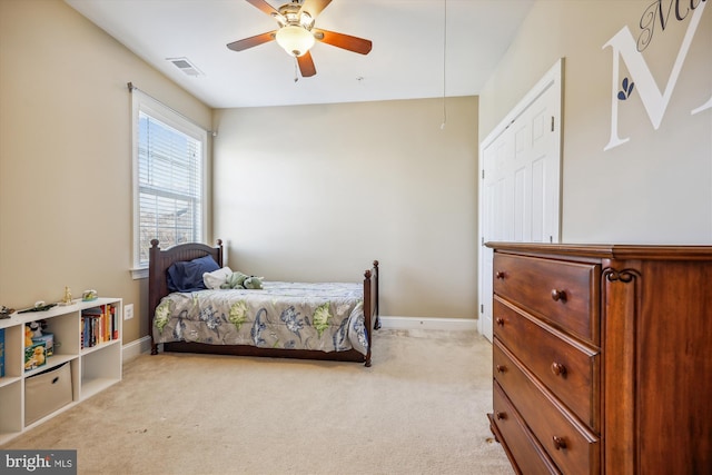 bedroom with attic access, light colored carpet, visible vents, and baseboards