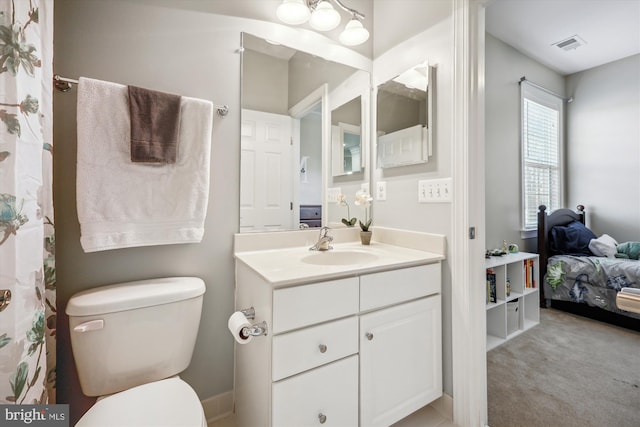 bathroom with visible vents, vanity, and toilet