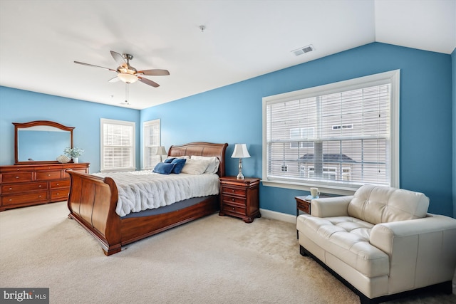 bedroom with light carpet, ceiling fan, visible vents, and lofted ceiling