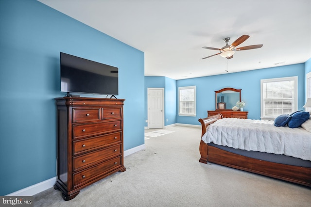 carpeted bedroom featuring visible vents, baseboards, and a ceiling fan