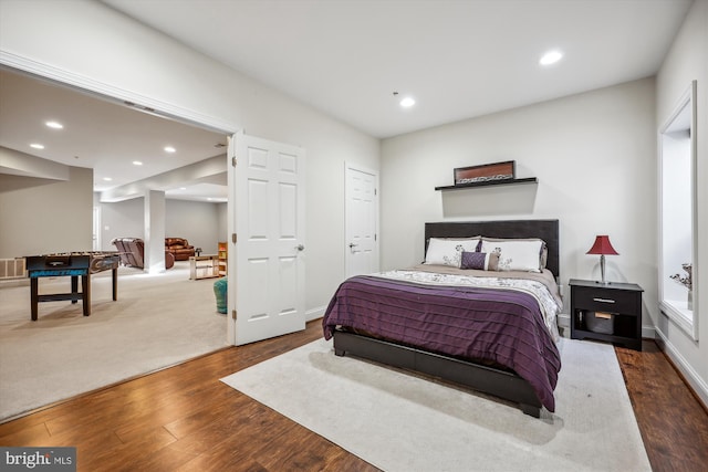 bedroom featuring recessed lighting, visible vents, baseboards, and wood finished floors